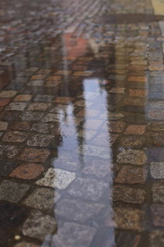 Reflection in a puddle on the wet pavement