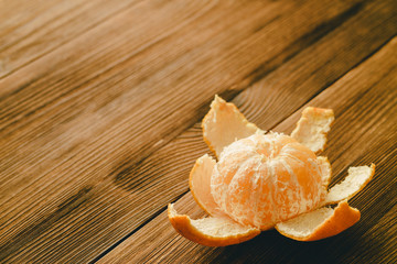 Purified tangerine on a wooden table.
