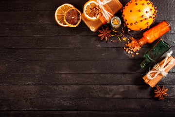 spa concept on wooden background: Aromatic oils, salt, soap, citrus, cinnamon candles. top view