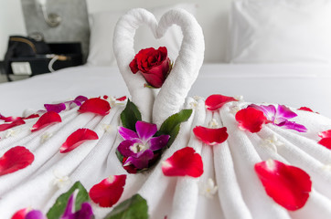 Honeymoon decoration with towels and rose petals