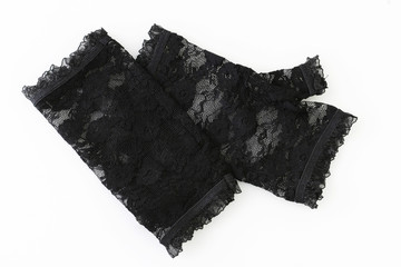  Womens pair of black lace gloves on a white background.