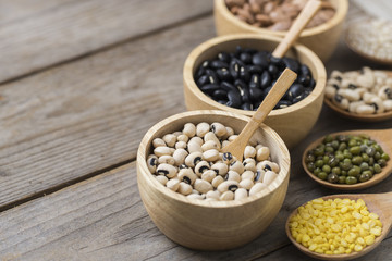 Group of beans on wood table background