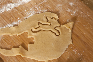 Christmas Preparations. The making of gingerbread is a time honored tradition. The gingerbread is cut with shapes cutters from the rolled out dough, put on a baking tray and is ready for the oven.