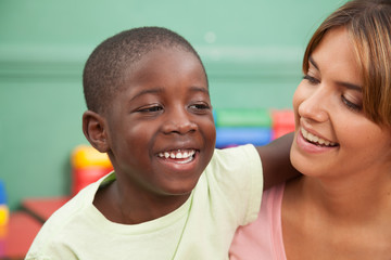 Kid smiling with her teacher