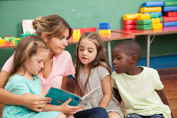 Teacher reading a book to her kindergarten class