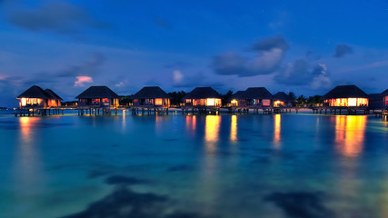 Fototapeta na wymiar Maldivian water bungalows at dusk