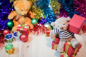 Obraz na płótnie Canvas Decorate Christmas and little bear on the wood floor select focus front bear