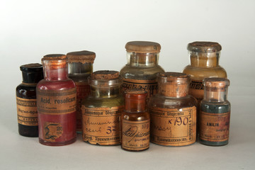 Vintage dye bottles on light background
