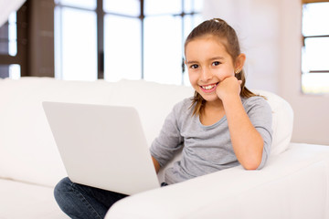 Fototapeta premium little girl using laptop