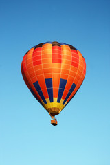 Orange balloon on blue sky