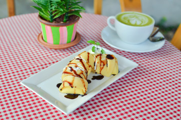banana roll cake on white plate.
