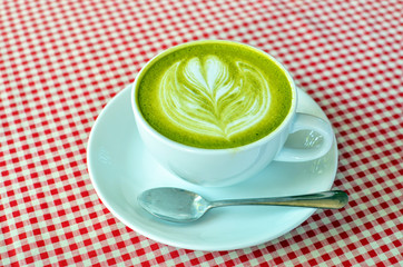 green tea latte on white cup.
