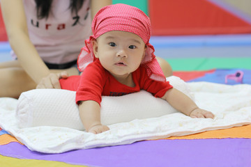 Five-month-old child in the play room. Asian Cute play Gym