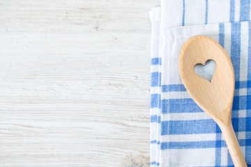 wooden spoon with heart on kitchen towel