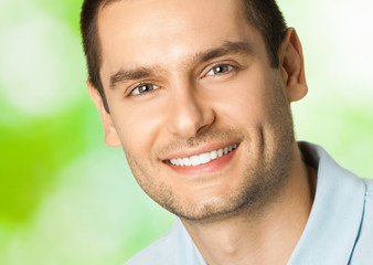 Handsome young smiling man, outdoor
