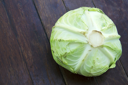 Cabbage on a wooden floor in the background.