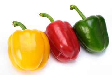 red green and yellow Sweet peppers on white background