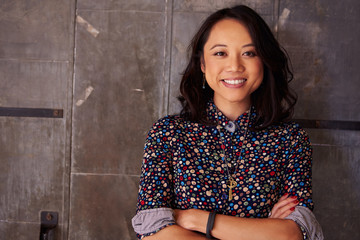 Portrait Of Female Designer Standing In Modern Office