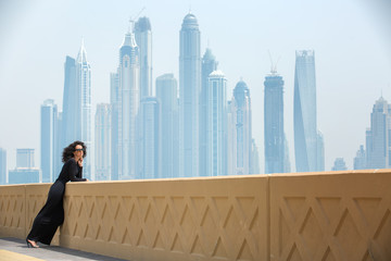 Woman on the background of skyscrapers