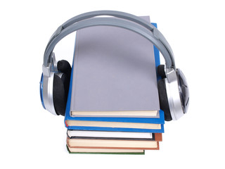 Stack of books and headphones on white background