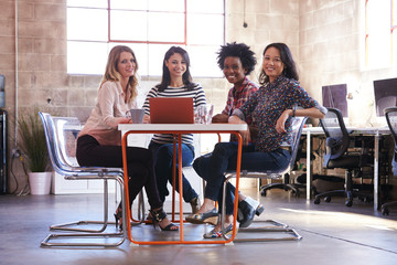 Group Of Female Designers Having Meeting In Modern Office