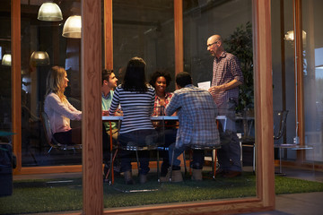 Late Night Meeting Around Table In Design Office