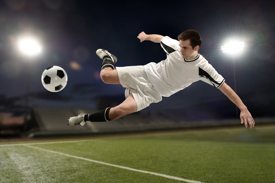 Soccer player jumping and kicking