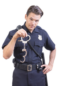 Uniformed police officer holding handcuffs