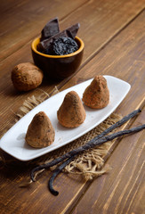 Vegan Homemade Candies with prunes and nuts in cocoa powder.