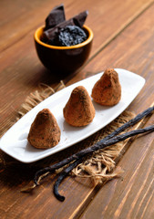 Vegan Homemade Candies with prunes and nuts in cocoa powder.