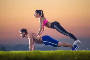 fitness pair exercise push ups on sunset