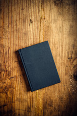 Black notebook on wooden office desk