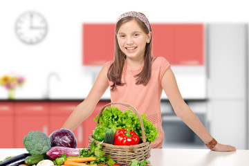 smiling young girl in a kitchen, standing behind a pile vegetabl