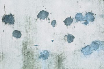 Splodgy grey wall background with blue spots