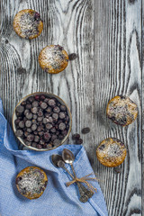 Five muffins with blackcurrant top view, vertical frame