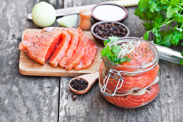 Salted  salmon in glass jar on an old wooden table