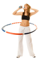 sporty fit girl doing exercise with hula hoop.