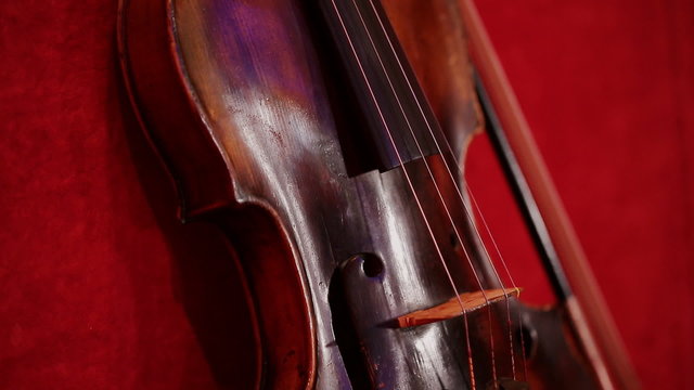 Violin on the beautiful red background.