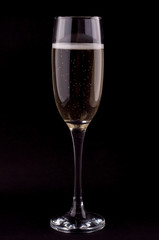 A glass of champagne on black background