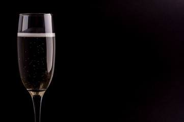 A glass of champagne on black background