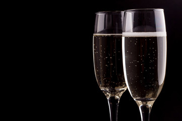 A glass of champagne on black background