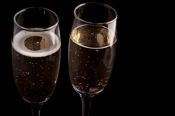 A glass of champagne on black background