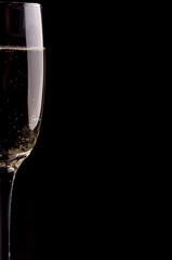 A glass of champagne on black background