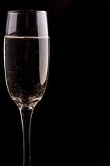 A glass of champagne on black background