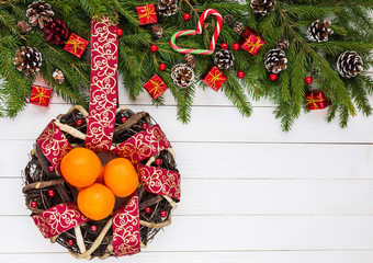 Christmas background. Christmas tree, decoration,  wreath with  ribbon and tangerines. Copy space