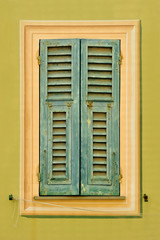 Fototapeta premium Old window shutters on the light green wall