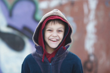 portrait of a little happy homeless boy