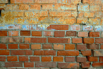 Half painted brick wall. Textured background. Vintage looking detail. Astrakhan, Russia. Concrete cracked wall as a grunge background