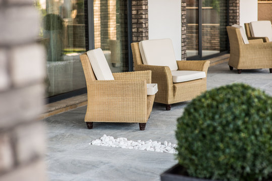 Armchairs on open terrace in luxury villa exterior