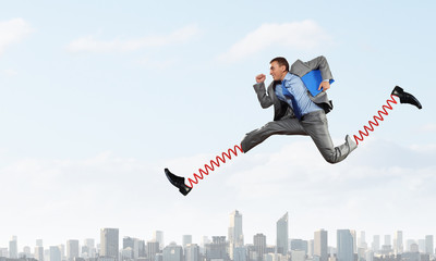 Businessman making wide jump